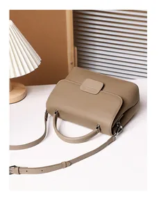 Close-up of litchi grain cowhide leather texture and side gusset of shell crossbody bag