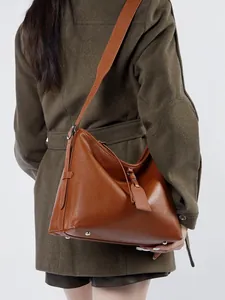 Vintage brown leather hobo shoulder bag with wide strap and protective base rivets