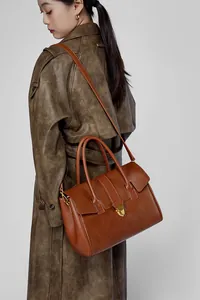 Dettaglio della borsa tote in pelle marrone vintage con fibbia dorata e tracolla rimovibile