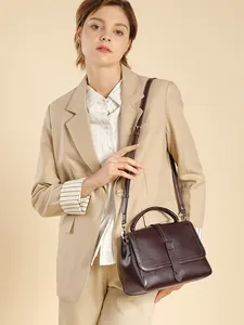 Elegant deep burgundy genuine leather handbag with top handle and crossbody strap