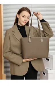 Detailed side view of large leather tote bag with lychee grain and adjustable strap