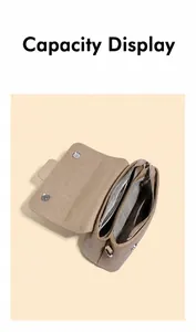 Top-down view showing interior compartments and magnetic buckles of a taupe leather handbag