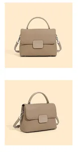 Detail of khaki pebbled leather texture on vintage shell bag with silver hardware