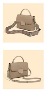 Detail of khaki pebbled leather shell bag with detachable ethnic woven and leather straps