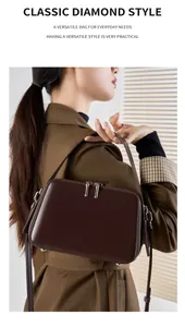 Detail of a dark brown leather crossbody bag paired with a stylish autumn trench coat