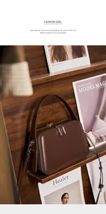 Detailed macro of vintage dark brown leather handbag with silver metallic hardware accents