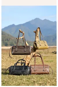 Detail shot of vintage leather baguette bags in four colors against natural background