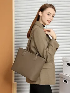 Classic dark brown pebble leather tote bag for women shown with professional female model
