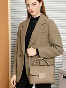 Classic terracotta leather shell bag with lychee texture shown on model for elegant daily look