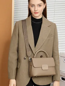 Classic earth-tone leather shell bag with woven strap and top handle in city style