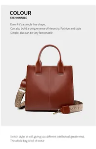 Dettaglio borsa tote in pelle marrone scuro con ampia tracolla ricamata e cucitura centrale