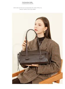 Detail of dark brown leather handbag texture with flap design and slim strap