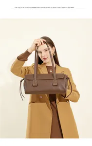 Detail of the vintage dark brown leather shoulder bag with drawstring side accents