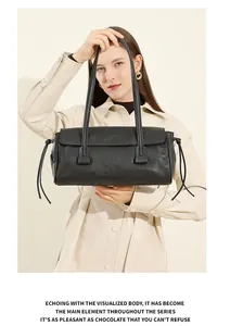 Detail of black leather handbag featuring delicate side knots and fine texture