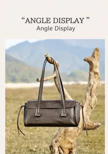 Close-up of dark brown leather shoulder bag featuring fine grain texture on nature wood