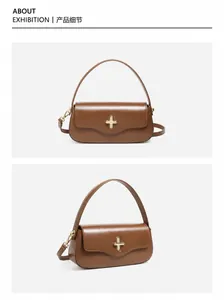 Macro shot of premium brown leather bag featuring an elegant gold cross-shaped clasp