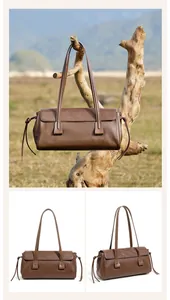 Detail of brown leather handbag with slim straps and side knot in natural outdoor setting