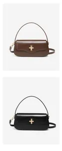 Detail of leather underarm bags with gold cross locks in dark brown and black