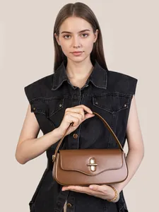 Retro brown leather baguette shoulder bag with gold oval twist lock and sleek finish