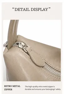 Dettaglio della cerniera in metallo vintage e texture in pelle sulla borsa a bauletto
