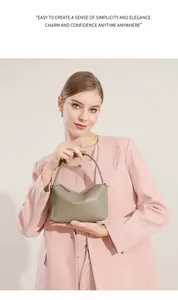 Dettaglio borsa in pelle grigio-khaki con manici sottili e chiusura lampo rifinita