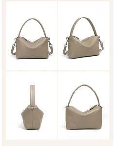 Viste dettagliate di una borsa in pelle kaki con manici e ganci metallici per tracolla
