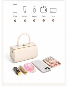 Detailed internal view showing box bag capacity with phone, wallet and cosmetics inside