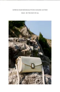 Detail of cream genuine leather shoulder bag with vintage gold metal lock on rocks