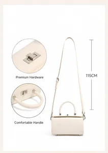 Detail view of cream leather box bag with silver lock and 115cm adjustable strap
