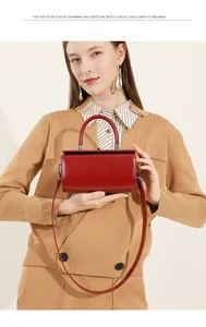 Close-up of a red leather square box bag with silver hardware and a top handle