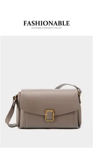 Detail of a minimalist clay mauve leather shoulder bag with golden rectangular buckle