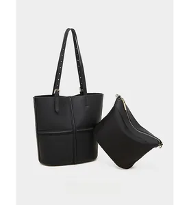 Detail of black pebbled leather tote set with gold hardware and inner zipper pouch