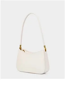 Close-up of cream leather shoulder bag with elegant gold buckle and smooth zipper detail