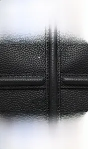 Detail of high-quality black lychee grain leather texture on premium cowhide tote bag