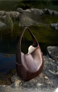 Detail of premium textured leather hobo bag in chocolate brown with spacious interior