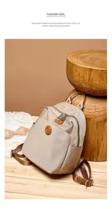 Detail of light beige water-resistant oxford backpack with premium leather accents