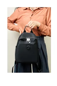 Detail of waterproof oxford and leather backpack with a circular embossed G-logo