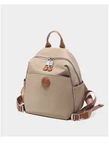 Detail of oxford cloth backpack with leather pullers and side pocket in khaki
