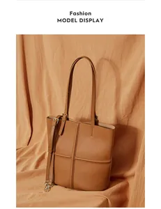 Detail of caramel leather tote bag with cross stitching and removable shoulder strap