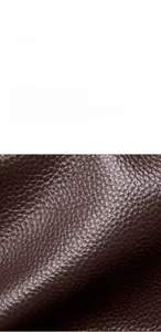 Macro shot of dark brown first layer cowhide leather texture with natural grain