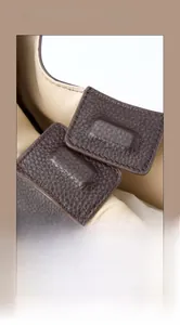 Detail of top layer cowhide leather texture and built-in magnetic closure for tote bag