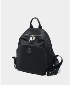 Detail view of water-resistant black oxford fabric and premium leather backpack straps