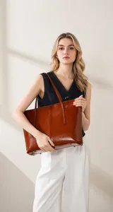 Fashionable large capacity cognac leather tote bag shown in a professional studio model shot