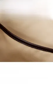Detailed close-up of high-quality stitching on premium leather crescent tote bag