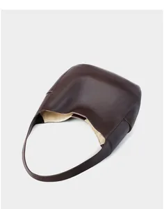 Top-down view of spacious dark brown leather tote bag with soft lychee grain texture