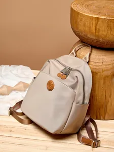Beige oxford cloth and leather backpack with large capacity and minimalist design