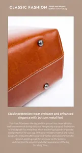 Detail view of brown leather tote base featuring protective silver metal bottom studs