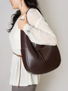Brown lychee texture leather hobo tote bag shown on model with white knit dress