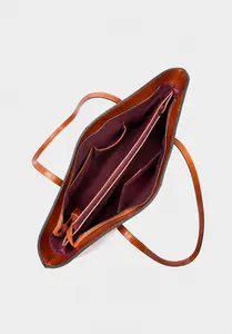 Internal view showing two main compartments and zipper pockets in brown leather tote bag