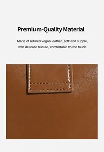 Detailed view of dark brown leather texture with precise stitching on a luxury handbag